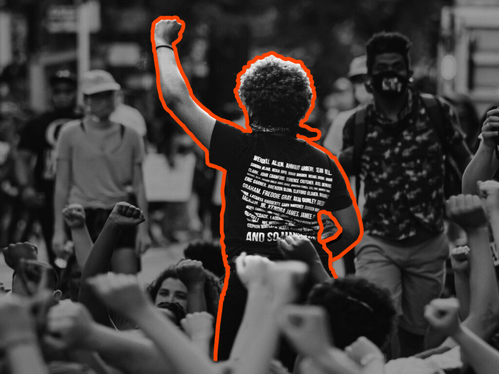 a leads a crowd in raising their fists